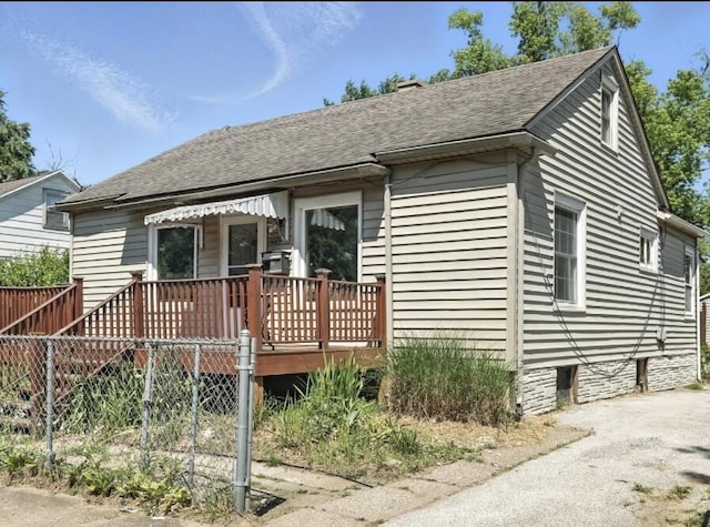 1079 Hurd Ave, Benton Harbor, MI 49022 - bungalow-style home featuring a shingled roof and a wooden deck