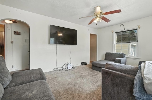 1079 Hurd Ave, Benton Harbor, MI 49022 - living area featuring arched walkways, ceiling fan, and carpet floors