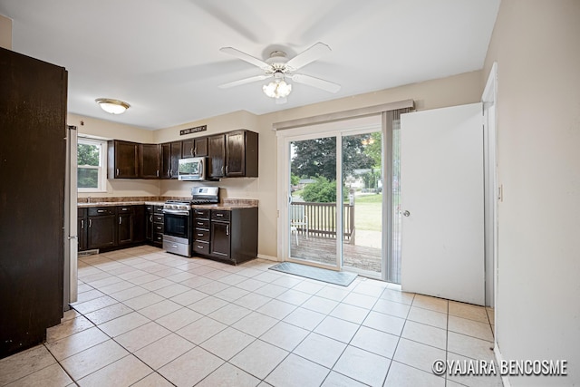 2751 Valley Ave NW, Grand Rapids, MI 49544 - kitchen featuring stainless steel appliances, dark brown cabinetry, light countertops, ceiling fan, and light tile patterned flooring