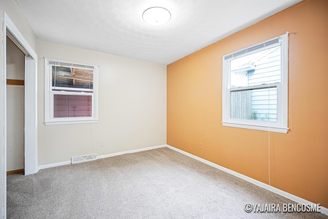 2751 Valley Ave NW, Grand Rapids, MI 49544 - unfurnished bedroom with carpet and a closet
