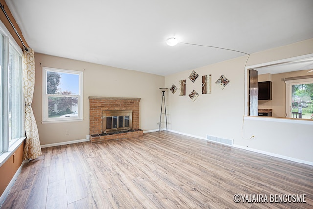 2751 Valley Ave NW, Grand Rapids, MI 49544 - unfurnished living room with wood finished floors and a fireplace