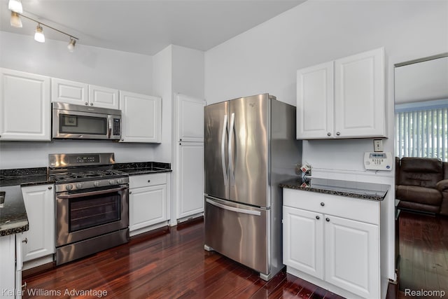 9428 Oak St, Taylor, MI 48180 - kitchen with appliances with stainless steel finishes, white cabinetry, dark wood-style floors, and dark stone countertops