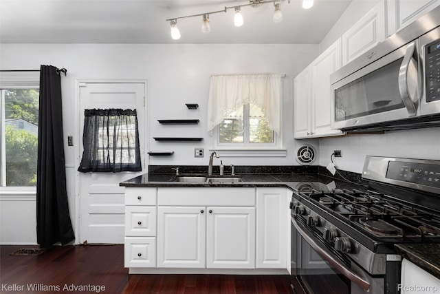 9428 Oak St, Taylor, MI 48180 - kitchen featuring appliances with stainless steel finishes, white cabinets, dark stone counters, and dark wood-style floors