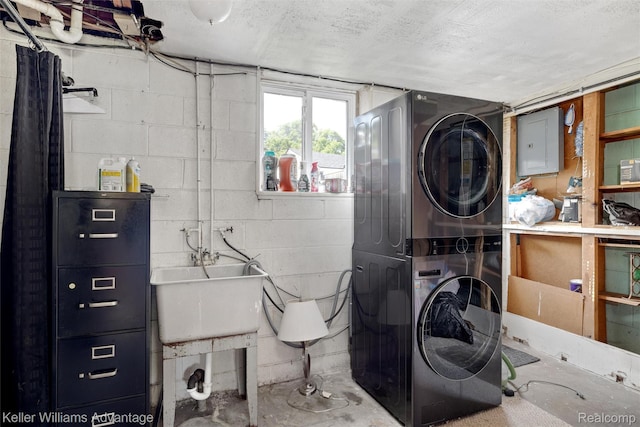 9428 Oak St, Taylor, MI 48180 - laundry room with stacked washer and clothes dryer, electric panel, and concrete block wall