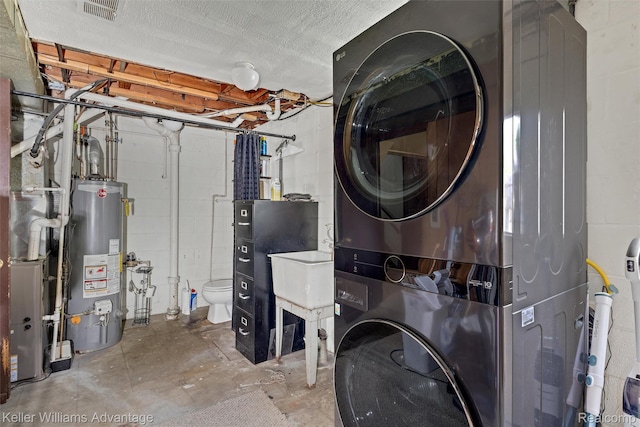 9428 Oak St, Taylor, MI 48180 - laundry area with gas water heater, stacked washer / dryer, and concrete block wall