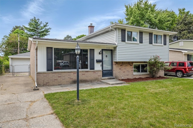 9428 Oak St, Taylor, MI 48180 - split level home with a chimney, brick siding, and a garage