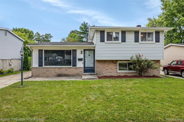 9428 Oak St, Taylor, MI 48180 - tri-level home featuring brick siding and a front yard