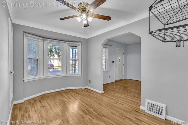 9624 Columbia, Redford, MI 48239 - empty room with light wood-style flooring, a ceiling fan, and arched walkways