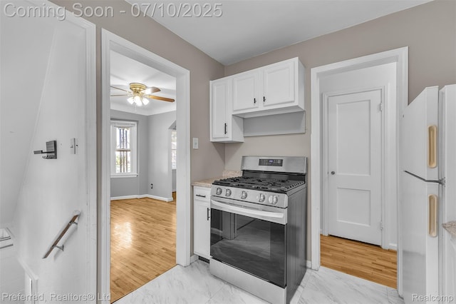 9624 Columbia, Redford, MI 48239 - kitchen with stainless steel gas stove, freestanding refrigerator, a ceiling fan, white cabinets, and light countertops