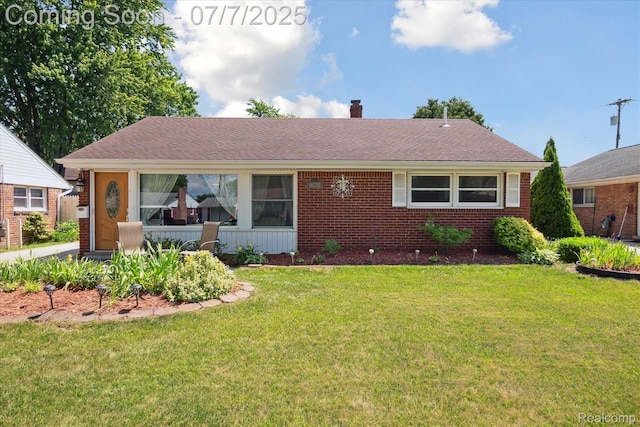 18735 Valade St, Riverview, MI 48193 - view of front of property with a chimney, a front lawn, brick siding, and roof with shingles