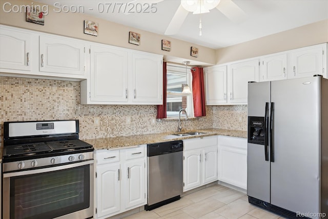 18735 Valade St, Riverview, MI 48193 - kitchen featuring stainless steel appliances, white cabinets, light stone countertops, and tasteful backsplash