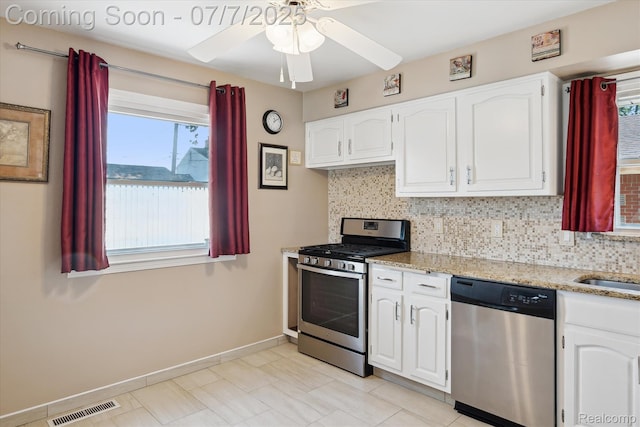 18735 Valade St, Riverview, MI 48193 - kitchen featuring stainless steel appliances, white cabinets, backsplash, and a ceiling fan