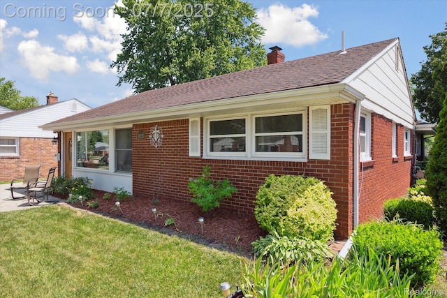 18735 Valade St, Riverview, MI 48193 - single story home featuring brick siding, a chimney, a front lawn, a patio, and a shingled roof