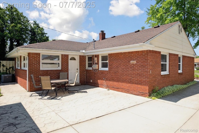 18735 Valade St, Riverview, MI 48193 - rear view of property with brick siding, a patio, a chimney, and roof with shingles