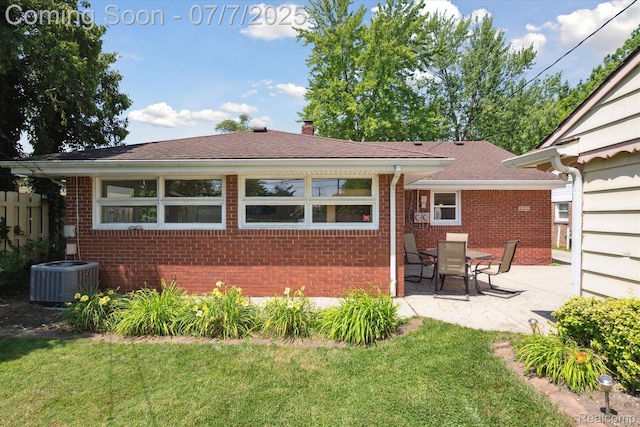 18735 Valade St, Riverview, MI 48193 - view of front of property with brick siding, a patio area, a front yard, and a chimney