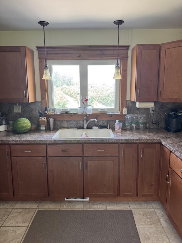 3338 Abbey Rd, Hart, MI 49420 - kitchen with healthy amount of natural light, backsplash, and hanging light fixtures