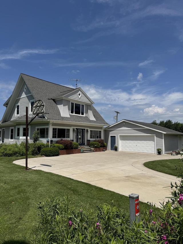3338 Abbey Rd, Hart, MI 49420 - view of front of property with a garage, concrete driveway, a front yard, and a shingled roof