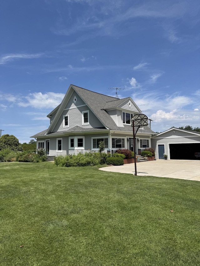 3338 Abbey Rd, Hart, MI 49420 - view of front of house featuring a front yard, an outbuilding, concrete driveway, and roof with shingles
