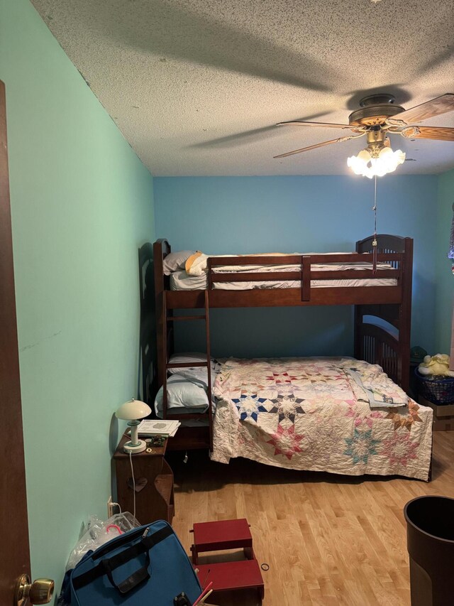 3338 Abbey Rd, Hart, MI 49420 - bedroom with wood finished floors, a textured ceiling, and a ceiling fan