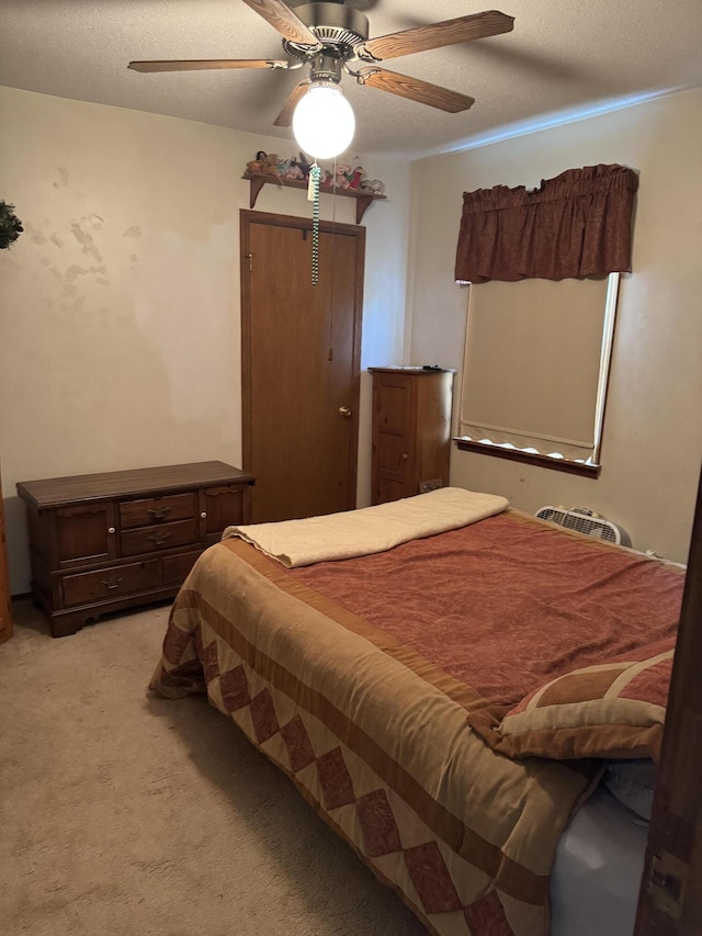 3338 Abbey Rd, Hart, MI 49420 - bedroom with light carpet, ceiling fan, and a textured ceiling