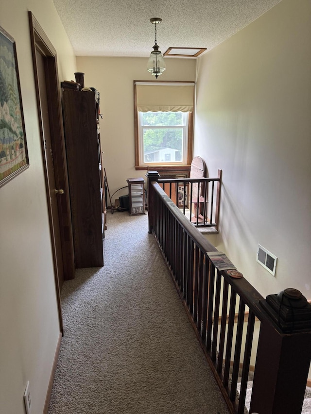 3338 Abbey Rd, Hart, MI 49420 - corridor featuring an upstairs landing, carpet flooring, and a textured ceiling