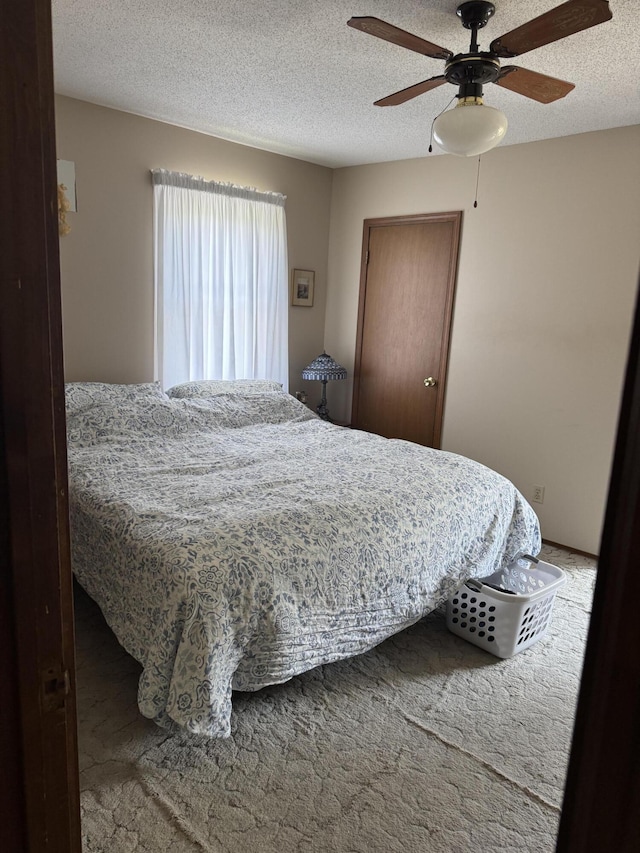 3338 Abbey Rd, Hart, MI 49420 - carpeted bedroom featuring a ceiling fan and a textured ceiling