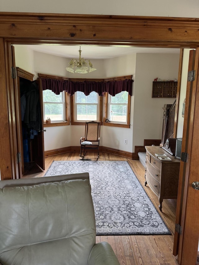 3338 Abbey Rd, Hart, MI 49420 - bedroom featuring wood finished floors and a chandelier