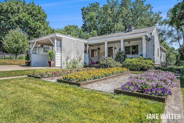 816 Malta St NE, Grand Rapids, MI 49503 - view of front facade featuring a garden, a chimney, and board and batten siding
