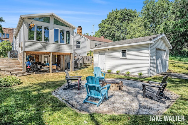 816 Malta St NE, Grand Rapids, MI 49503 - rear view of property featuring a fire pit, stairs, an outdoor structure, a lawn, and a patio