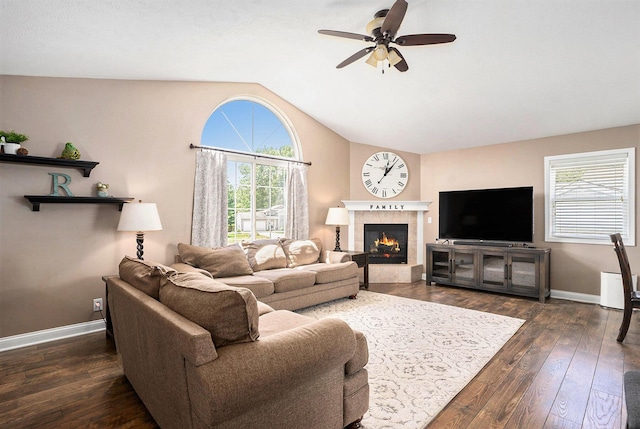 13757 Duncan St, Holland, MI 49424 - living area with vaulted ceiling, ceiling fan, dark wood-style floors, and a tile fireplace