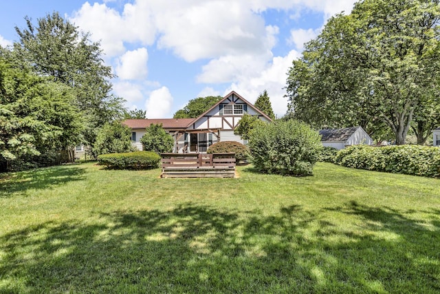 1007 Oak Grove Rd, Jackson, MI 49203 - back of property featuring a lawn and a wooden deck