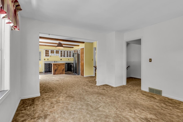 1007 Oak Grove Rd, Jackson, MI 49203 - unfurnished living room featuring carpet flooring and bar