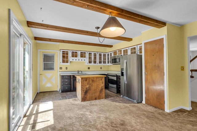 1007 Oak Grove Rd, Jackson, MI 49203 - kitchen with stainless steel appliances, a kitchen island, dark carpet, plenty of natural light, and beamed ceiling