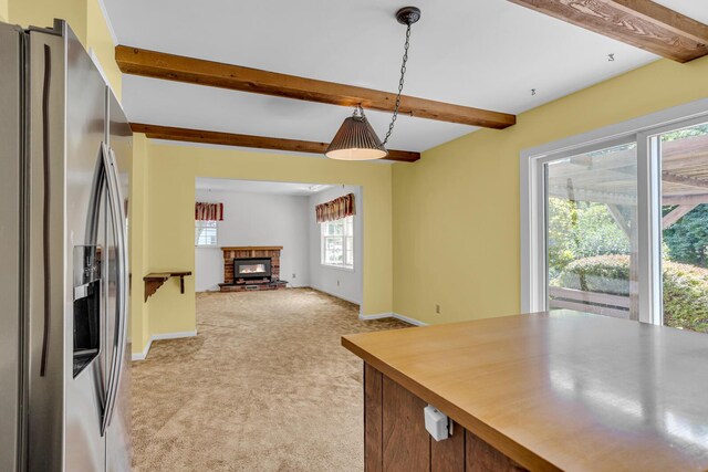 1007 Oak Grove Rd, Jackson, MI 49203 - kitchen featuring stainless steel refrigerator with ice dispenser, light colored carpet, beamed ceiling, hanging light fixtures, and open floor plan