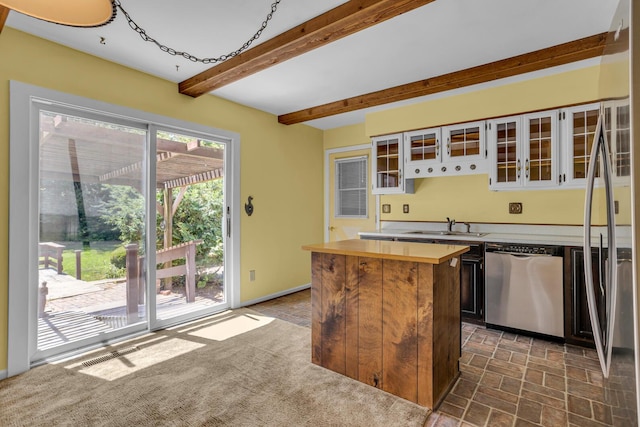 1007 Oak Grove Rd, Jackson, MI 49203 - kitchen featuring appliances with stainless steel finishes, wooden counters, a center island, beamed ceiling, and glass insert cabinets