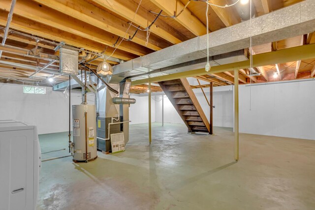 1007 Oak Grove Rd, Jackson, MI 49203 - below grade area featuring washer / dryer, gas water heater, stairway, and heating unit