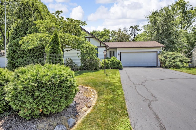 1007 Oak Grove Rd, Jackson, MI 49203 - view of front of house with driveway, a garage, and a front lawn