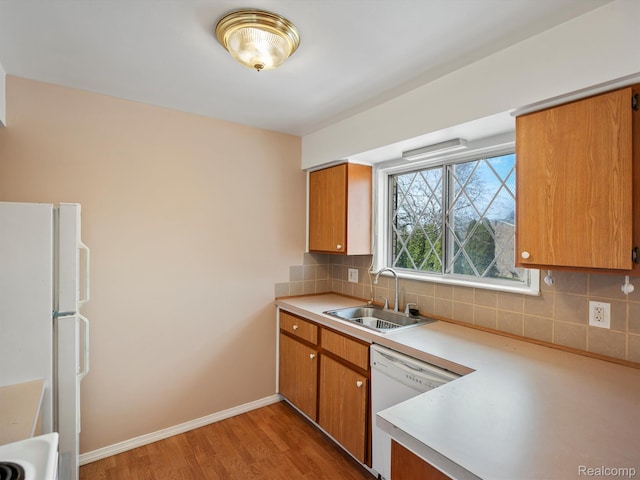 29272 Gloede Dr Unit 16, Warren, MI 48088 - kitchen featuring white appliances, light countertops, light wood finished floors, decorative backsplash, and brown cabinetry