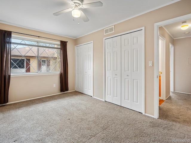 29272 Gloede Dr Unit 16, Warren, MI 48088 - unfurnished bedroom with multiple closets, carpet flooring, crown molding, and a ceiling fan