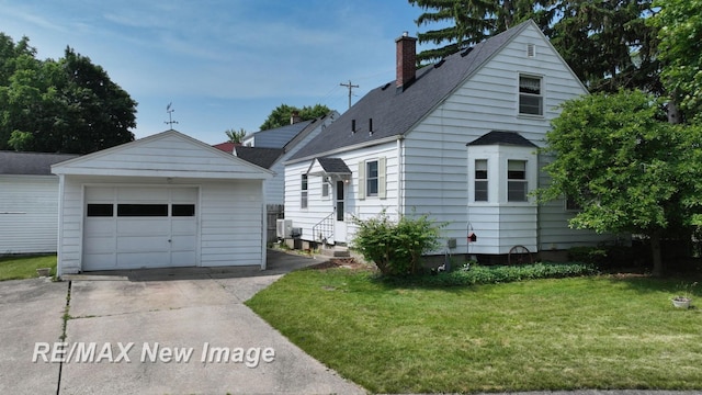 508 Malzahn St, Saginaw, MI 48602 - view of front of property with a chimney, concrete driveway, an outdoor structure, a detached garage, and a front lawn