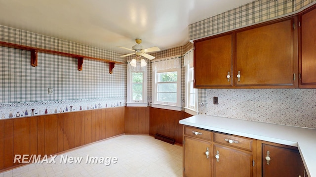 508 Malzahn St, Saginaw, MI 48602 - kitchen featuring wallpapered walls, brown cabinets, light countertops, and ceiling fan