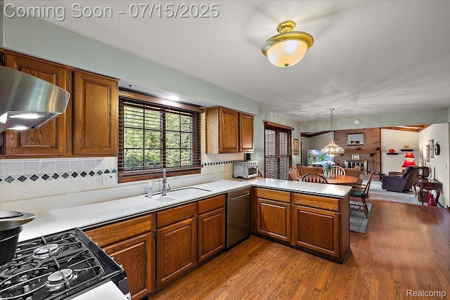 4516 Cahill Dr, Troy, MI 48098 - kitchen featuring dishwasher, a peninsula, light countertops, brown cabinets, and wood finished floors