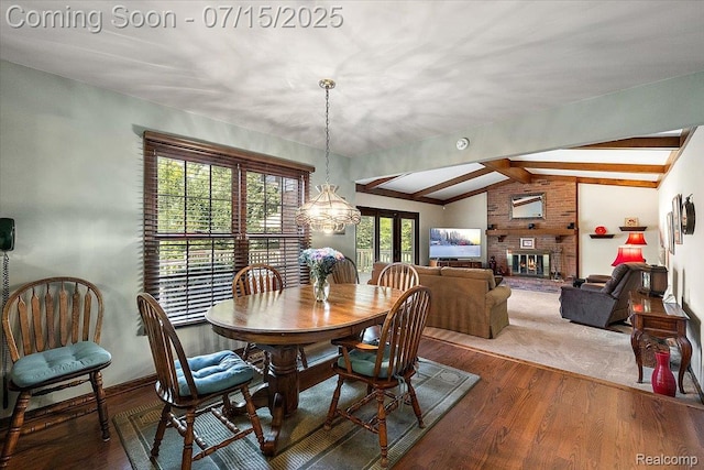 4516 Cahill Dr, Troy, MI 48098 - dining area featuring a brick fireplace, wood finished floors, french doors, and a chandelier
