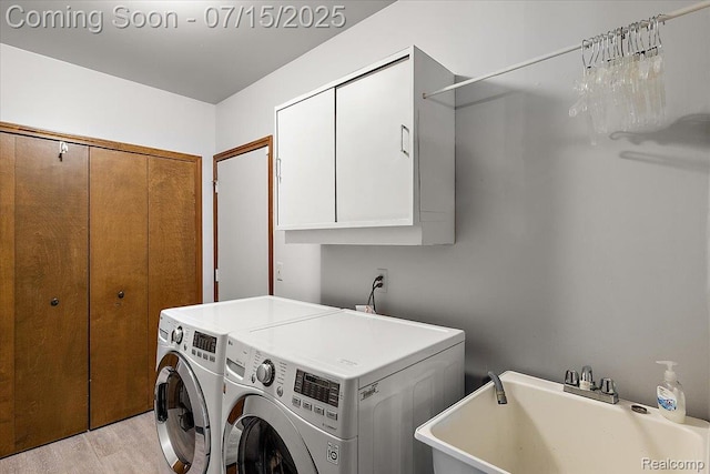 4516 Cahill Dr, Troy, MI 48098 - laundry room with washer and clothes dryer, cabinet space, and light wood-style floors