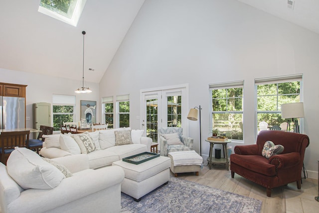 488 Solace Way S, Haven, MI 49090 - living room featuring high vaulted ceiling, a skylight, and light wood-style floors