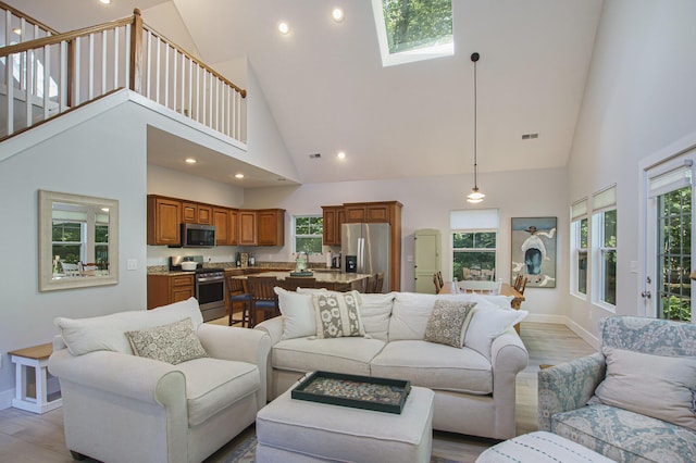 488 Solace Way S, Haven, MI 49090 - living room featuring high vaulted ceiling, a skylight, plenty of natural light, wood finished floors, and recessed lighting