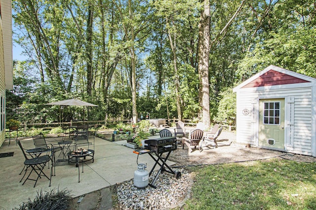 488 Solace Way S, Haven, MI 49090 - view of patio / terrace featuring a fire pit, a shed, and view of wooded area