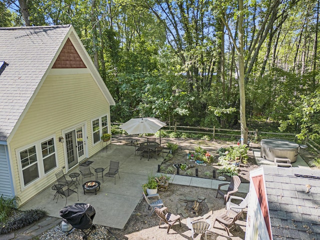 488 Solace Way S, Haven, MI 49090 - view of patio / terrace featuring an outdoor fire pit, a hot tub, outdoor dining space, grilling area, and french doors