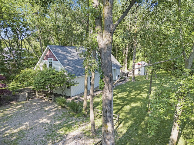 488 Solace Way S, Haven, MI 49090 - view of side of home featuring a shingled roof and a yard