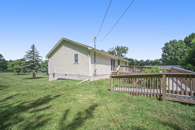 131 E Ave, Jackson, MI 49201 - view of side of property with a wooden deck and a lawn